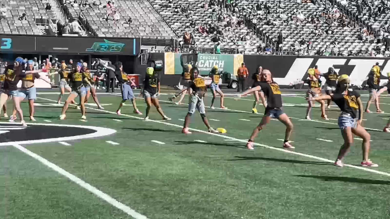IKONIK dancers performing in formation on an NFL field